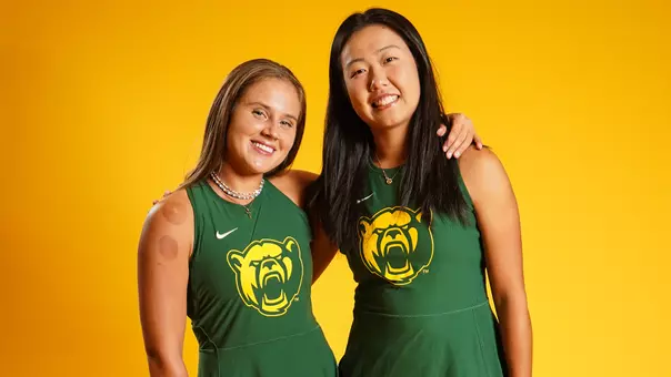 Zuzanna Kubacha and Na Dong post in front of gold background