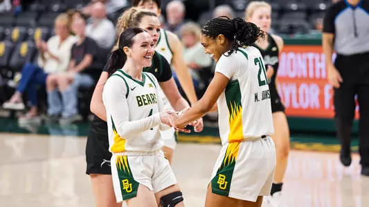 Jana Van Gytenbeek and Marcayla Johnson smile vs Le Moyne