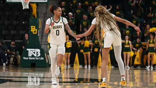 Taliah Scott and Darianna Littlepage-Buggs high five versus Southeastern Louisiana