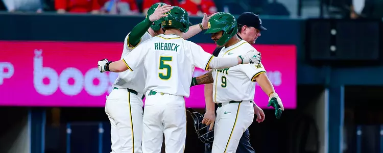 Hunter Simmons hugs his teammates after a home run at Globe Life in 2025