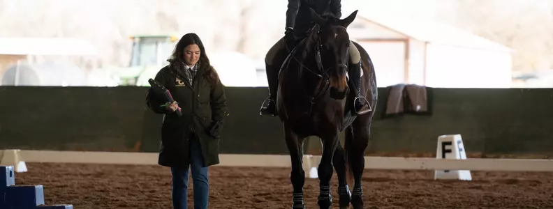 Coach Bridges with a student-athlete on horseback
