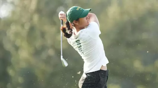 Amelia Wan swinging a golf club