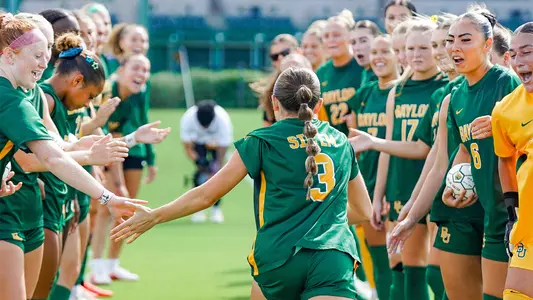 Natalie Vatter runs through team huddle during lineup announcements at home against K-State