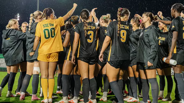 SOC team huddle postgame vs KU in the rain