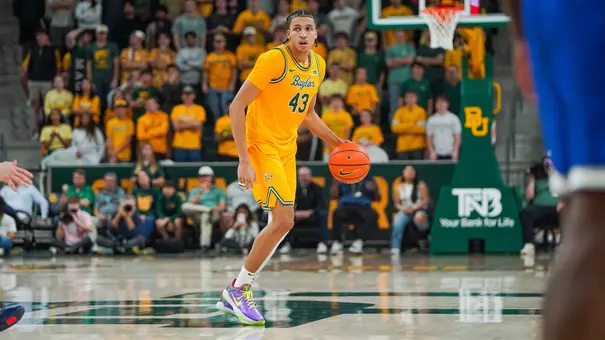 Cameron Carr dribbling against BYU at Foster Pavilion