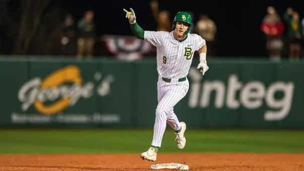 Brady Janusek rounds second base after hitting a home run 2026
