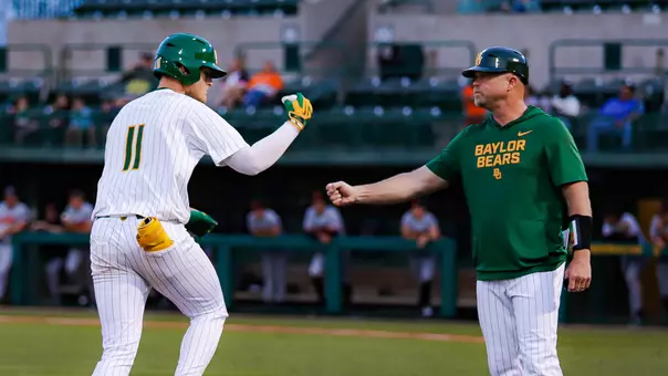 Tyce Armstrong fist bumps 3B coach Jim Blair after a home run vs Sam Houston