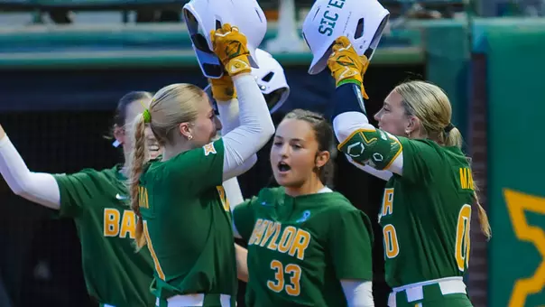 Leah Cran and Kaygen Marshall High Five after a homerun against UIW