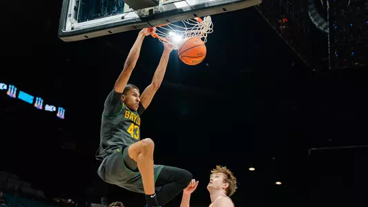 Cameron Carr dunking in Crown against Minnesota