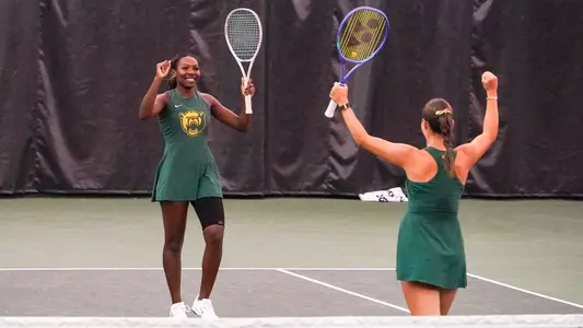 Kennedy Gibbs celebrates doubles point in the Hawkins Indoor over Utah