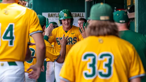 Brady Janusek high-fiving teammates in dugout 2026