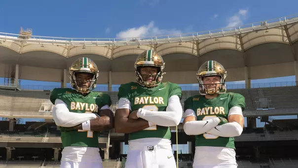 Louis Brown, DJ Lagway and Jacob Redding pose wearing the new throwback uniforms at McLane Stadium