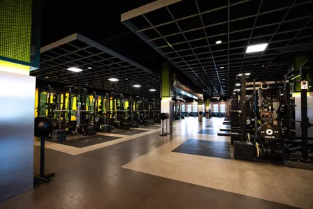 Simpson Athletics and Academic Center Weight Room images with racks of weights and dumbbells and weight benches