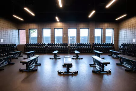 Simpson Athletics and Academic Center Weight Room images with racks of weights and dumbbells and weight benches