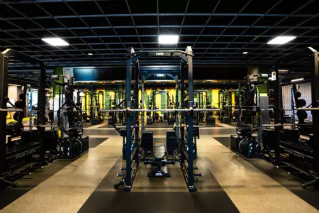 Simpson Athletics and Academic Center Weight Room images with racks of weights and dumbbells and weight benches