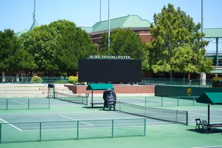 Exterior photos of the Hurd Tennis Center in 2026 featuring the courts, videoboard and grandstand seating