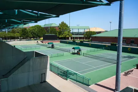 Exterior photos of the Hurd Tennis Center in 2026 featuring the courts, videoboard and grandstand seating