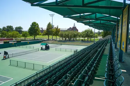 Exterior photos of the Hurd Tennis Center in 2026 featuring the courts, videoboard and grandstand seating