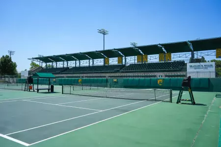 Exterior photos of the Hurd Tennis Center in 2026 featuring the courts, videoboard and grandstand seating