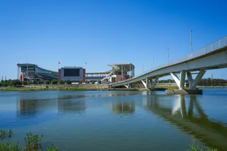 Exterior photos of McLane Stadium in 2026, including the RGIII statue, rear-facing videoboard and Umphrey pedestrian bridge
