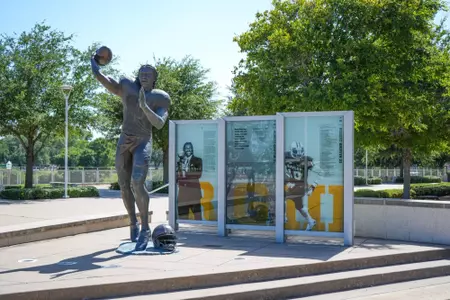Exterior photos of McLane Stadium in 2026, including the RGIII statue