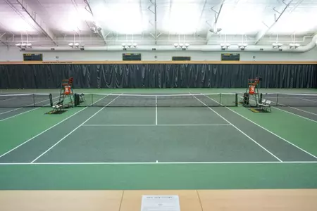Exterior and interior photo of Hawkins Indoor Tennis Center in 2026, showcasing the outside entrance, courts, lobby and seating areas