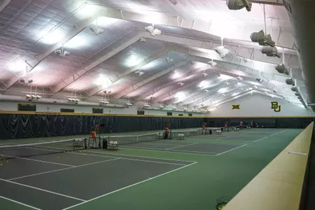Exterior and interior photo of Hawkins Indoor Tennis Center in 2026, showcasing the outside entrance, courts, lobby and seating areas