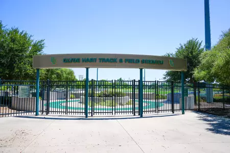 Exterior photos for Clyde Hart Track & Field Stadium in 2026, including the track, grandstands, buildings and Clyde Hart bust