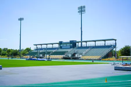 Exterior photos for Clyde Hart Track & Field Stadium in 2026, including the track, grandstands, buildings and Clyde Hart bust