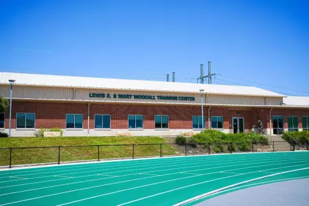 Exterior photos for Clyde Hart Track & Field Stadium in 2026, including the track, grandstands, buildings and Clyde Hart bust
