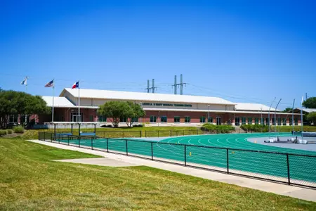 Exterior photos for Clyde Hart Track & Field Stadium in 2026, including the track, grandstands, buildings and Clyde Hart bust