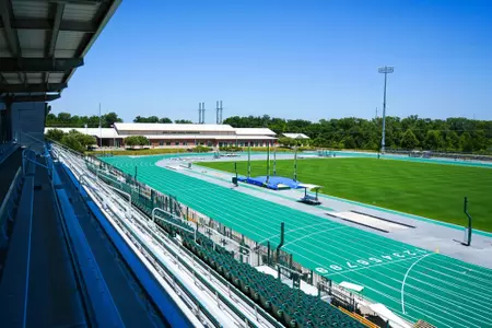 Exterior photos for Clyde Hart Track & Field Stadium in 2026, including the track, grandstands, buildings and Clyde Hart bust