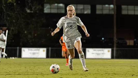 Lauren Omholt dribbles the soccer ball up Betty Lou Mays Field against Marquette