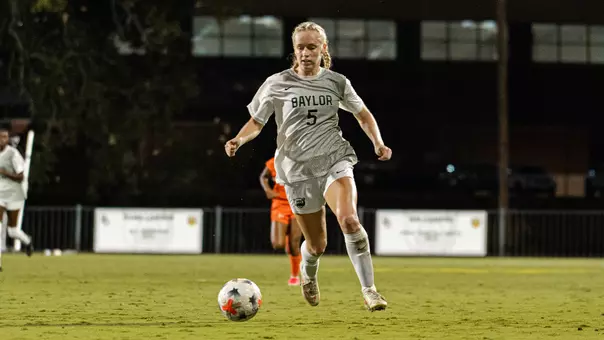Lauren Omholt dribbles the soccer ball up Betty Lou Mays Field against Marquette