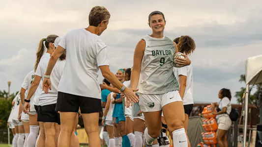 Callie Conrad high fives Michelle Lenard in starting lineup announcement