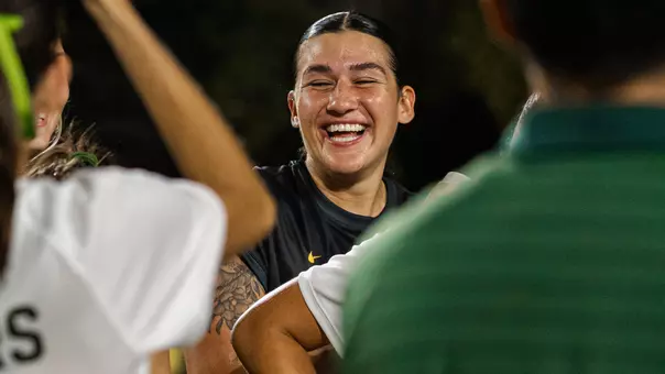 Azul Alvarez smiles and laughs while surrounded by teammates in celebration after Baylor soccer's win over Pepperdine.