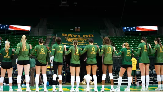 Baylor Volleyball Poses for the national Anthem before a match against UNT