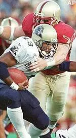 Chris Hovan wraps up<br>Pittsburgh's Kevan Barlow<br>in the first quarter<br>of Saturday's game.