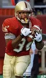 Jamal Burke pulls in a<br>long, first down pass from<br>quarterback Tim Hasselbeck<br>on third and 14 in<br>the second quarter.