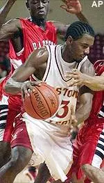 Xavier Singletary eludes two Harford defenders on his way to the hoop Monday night.