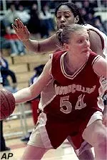 Becky Gottstein drives past<br>Natasha Johnson of St. John's<br>during first half action.