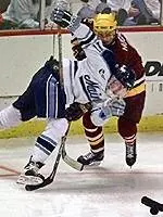Marty Hughs battles for <BR>the puck against Maine.