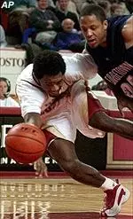 Xavier Singletary and Georgetown's Nathaniel Burton vie for a loose ball during first-half action Tuesday night.