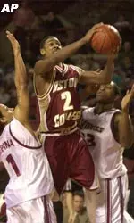 Boston College's <b>Troy Bell</B> goes for a shot between Massachusetts' Jonathan DePina and Kitwana Rhymer, right, during the first half at the Mullins Center in Amherst, Mass.