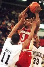 Providence College guards Abdul Mills and Donta Wade try to block the shot of Boston College forward Michael Cotton in the second half Saturday.