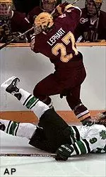 Mike Lephart dumps North Dakota forward Jason Ulmer to the ice during the first period of the NCAA Division I championship matchup Saturday.