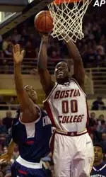 Boston College forward Uka Agabi (00) drives past Connecticut forward Edmund Saunders, left, and puts up a shot during the second half in Boston, Wednesday.