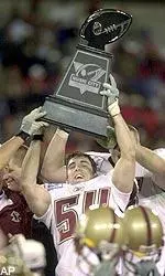 Linebacker Scott Bradley raises the Music City Bowl trophy.