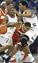Boston College's Troy Bell drives to the hoop around Providence's Erron Maxey in BC's win Saturday.