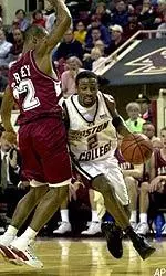 Guard Troy Bell drives to the basket as Saint Joseph's guard Tyrone Barly blocks the lane during the first half.